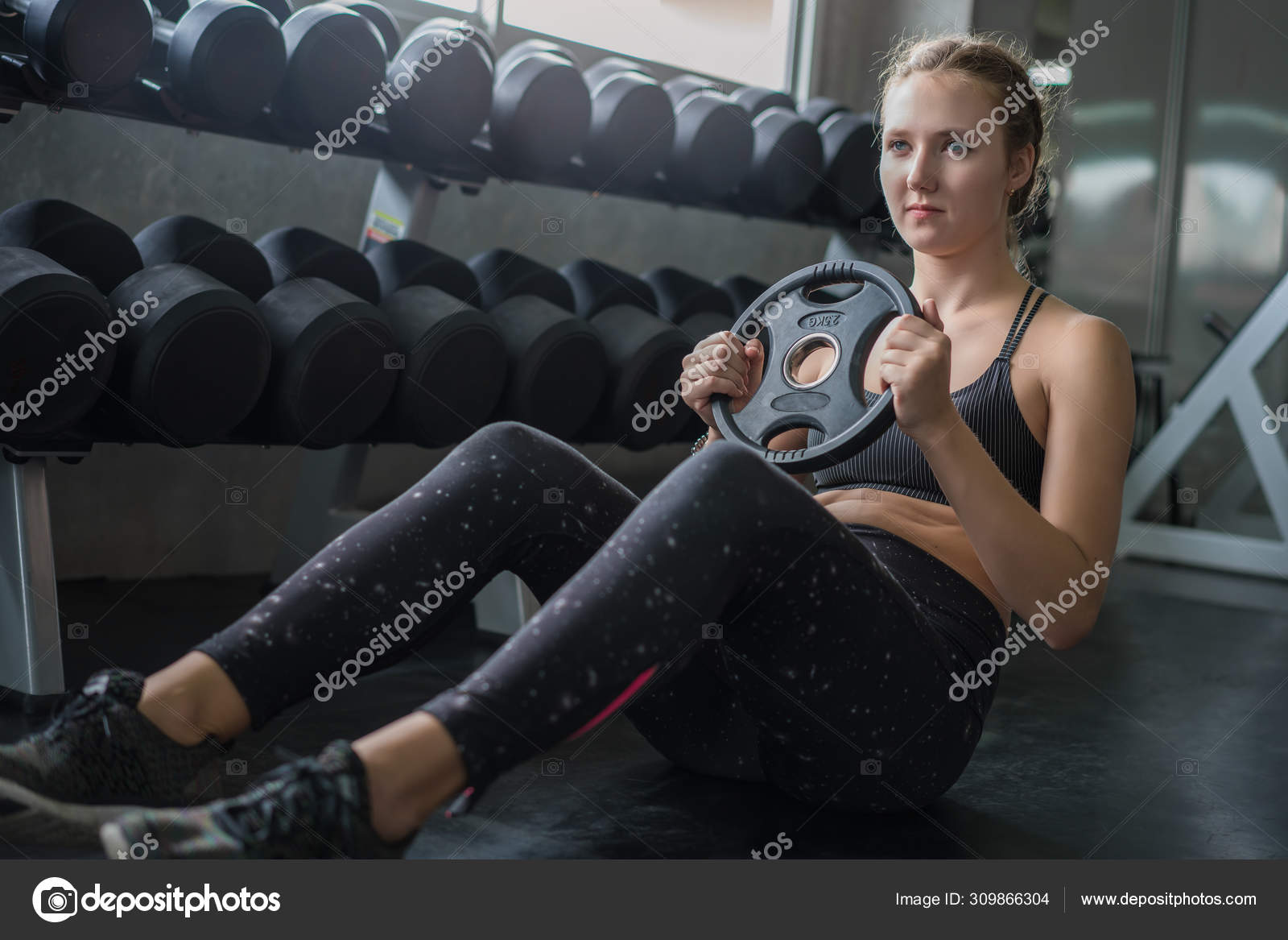Young Woman Weightlifter Lifting Bench Press Working Out With Du