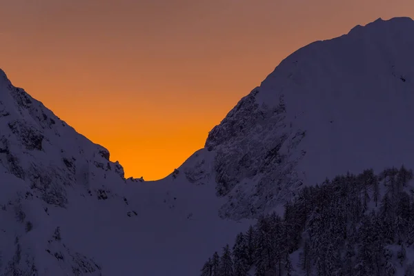 Червоний схід сонця в засніжених горах — стокове фото
