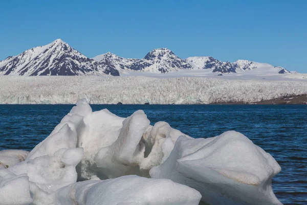 ice in front of Esmarkbreen glacier in Svalbard, blue sea