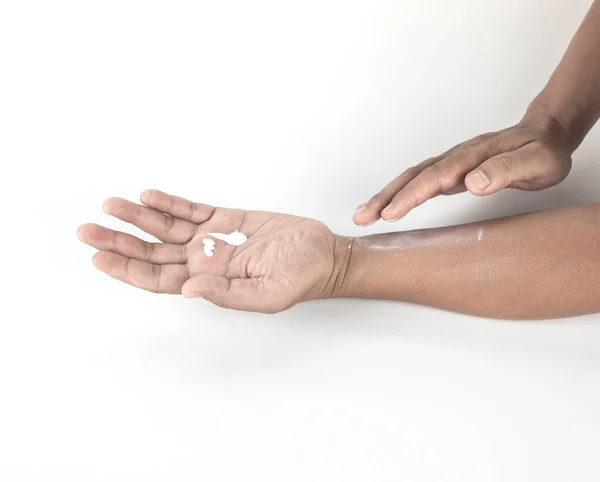 man applied body lotion on his  skin. image isolated on white background