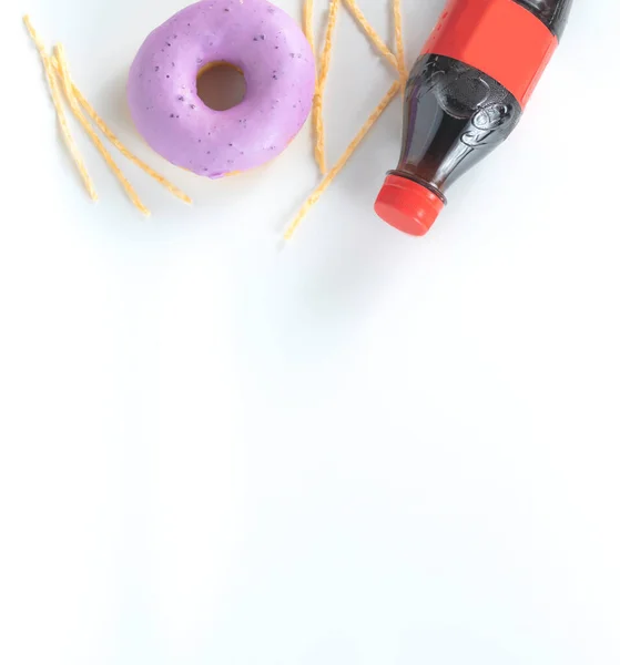 junk food dish such as donut,soft drink, fish fingers on white background,in top view with copy space