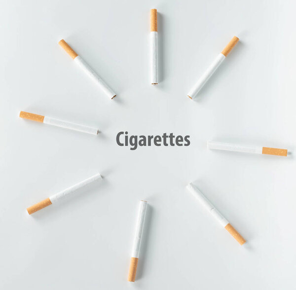 circle of cigarettes on white background from top view.