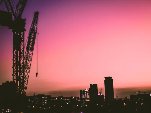 Puesta de sol rosa brillante. Casas y construcciones industriales contra la hermosa puesta de sol del cielo. Paisaje urbano, paisaje industrial . —  Fotos de Stock