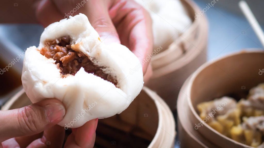 Chinese BBQ Pork Buns served .Dim sum, traditional Chinese dumplings, in bamboo steamer basket. Asian food