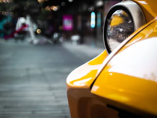 Head light Sport car in yellow  close up .lifestyle concept idea.road trip .travel background — Stock Photo, Image