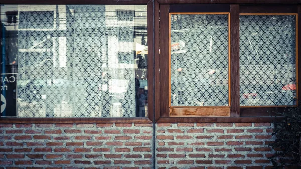 Oude bakstenen muur met bakstenen en mooi raam. witte rooster gordijn. — Stockfoto
