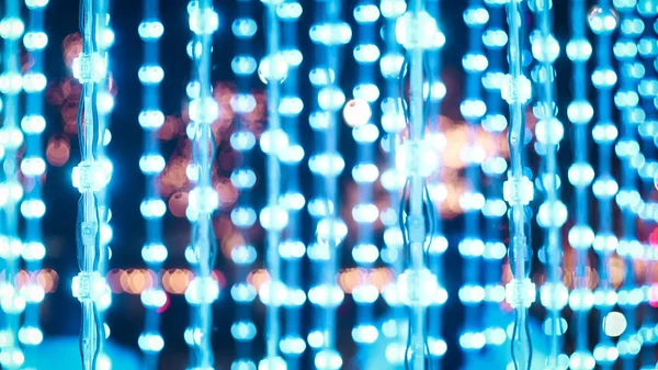 Blue string lights, wood background light bulbs bokeh