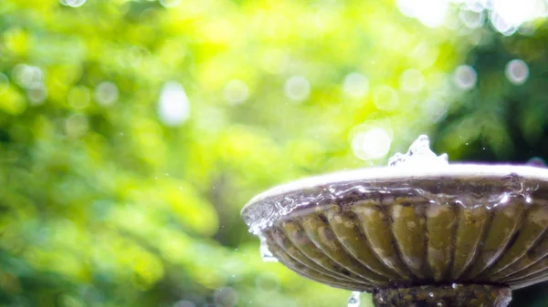 Antique fountain at garden. Water flowing from stone fountain. Design of antique fountain .calm and peacefulness concept idea