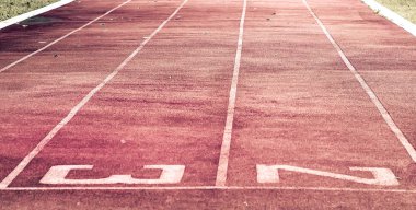 Starting line on running track .Red running track Synthetic rubber on the athletic stadium clipart