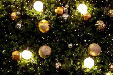 Noel ağacı çelenk ve süsler. Altın ve kırmızı topları ve şeritler asılı. Noel geçmişi. Yeni Yılınız Kutlu Olsun. Seçici odak tatil