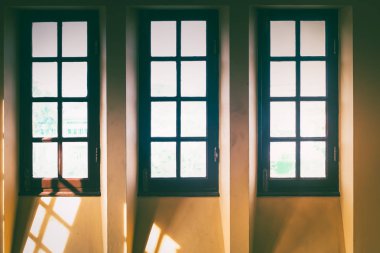 Eski şeffaf cam, kahverengi ahşap çerçeve penceresi beyaz ton duvar arka planında