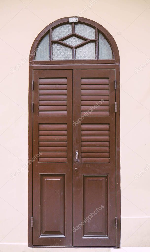 Vintage arched shutters, two panel rustic Mediterranean Shutter. Old wooden vintage louver window. Blinds Window Shutter Plantation Shutter in brown.