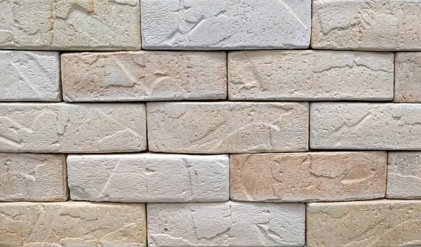 Beige tone stone brick background. Beige brick wall background texture close up