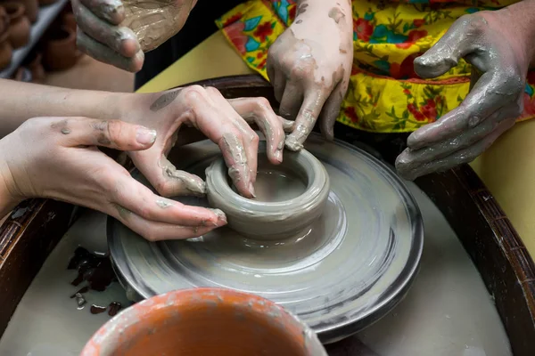 master class in a pottery workshop for a family