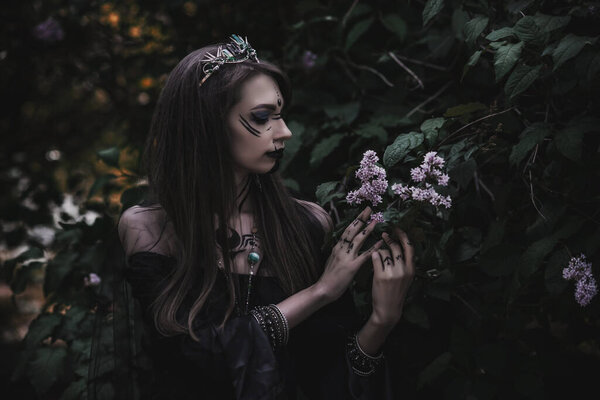 girl in a gothic gloomy image in a lilac