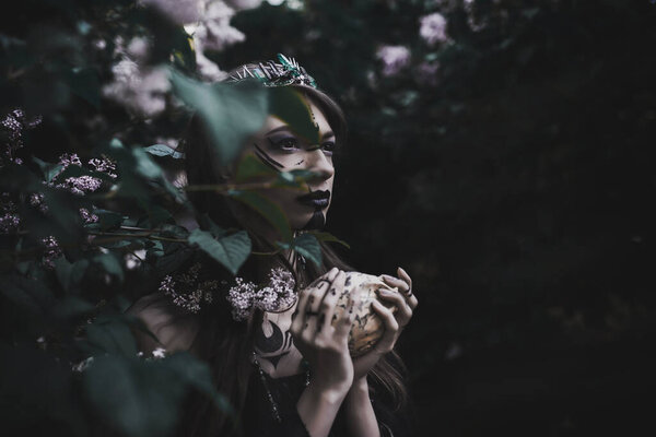 Girl in a gothic gloomy image in a lilac