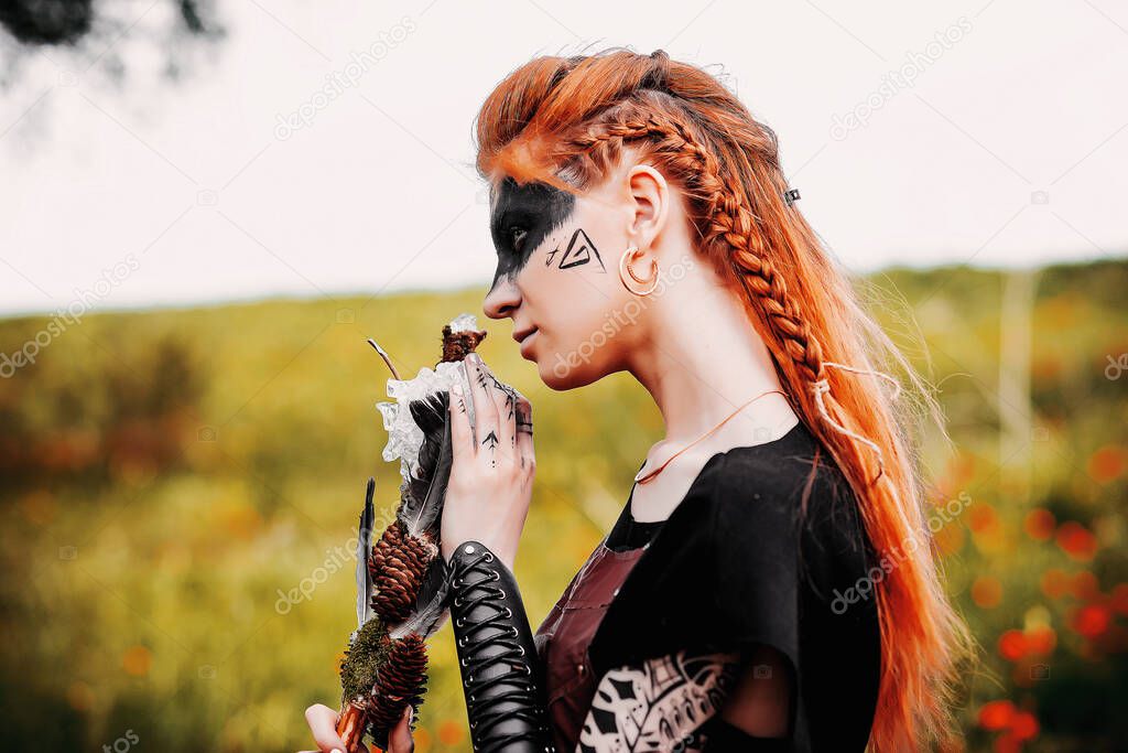 Girl in ethnic scandinavian costume in the forest