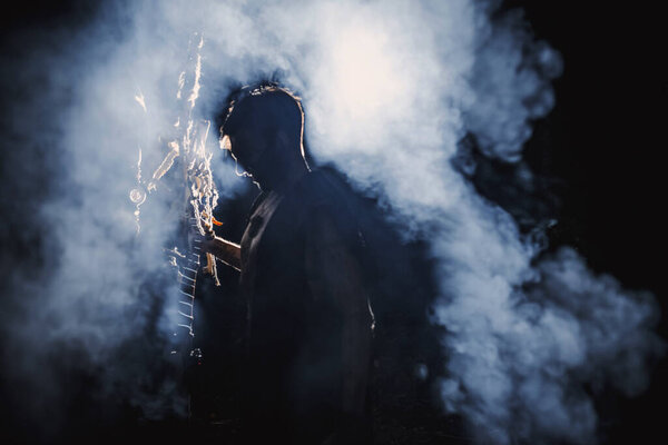 Sorcerer with marks on his body in the forest