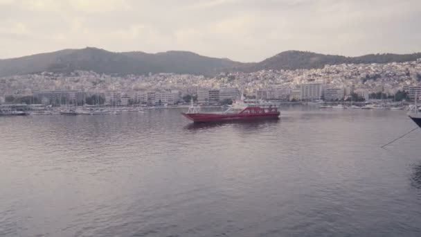 Horizontal view of Kavala docks in Greece. Red yacht staying still in calm waters — Stock Video