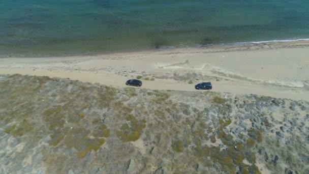 Aerial view of two cars driving at shore line in Lemnos,Greece — Stock Video