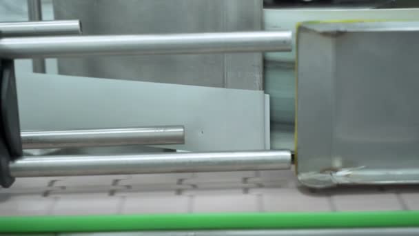 Close look of CBD oil bottle labeling machine line in laboratory — Stock Video