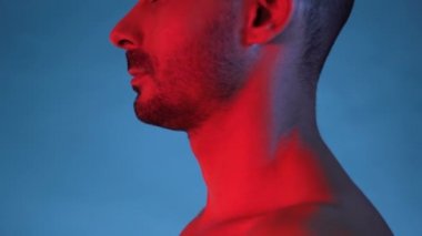 Mükemmel eğitimli, düzgün omuzları ve göğsü olan yakışıklı vücut geliştiricisinin stüdyo fotoğrafı.