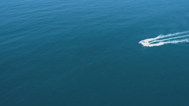 Speeding White boat leaving wide white foam trails in the turquoise waters of Black sea. Bulgaria — Stock Video