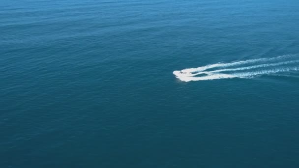 Aerial view of luxury white speed boat cruising in the blue calm sea — Stock Video