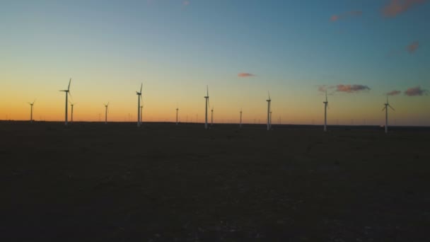 Widok z powietrza na sylwetki turbin wiatrowych na farmie wiatrowej przed zachodem słońca niebo — Wideo stockowe