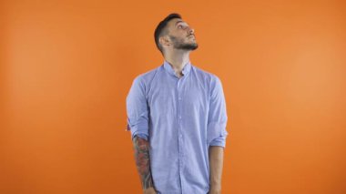 Kotlu ve gömlekli üzgün genç adam ceplerini boşaltıyor. Para kavramı yok. Kötü jestler