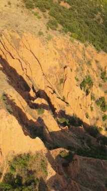 Cinematic vertical footage reveals the iconic sandstone pillars of the Stob Pyramids surrounded by scenic landscapes and natural beauty in rural Bulgaria.