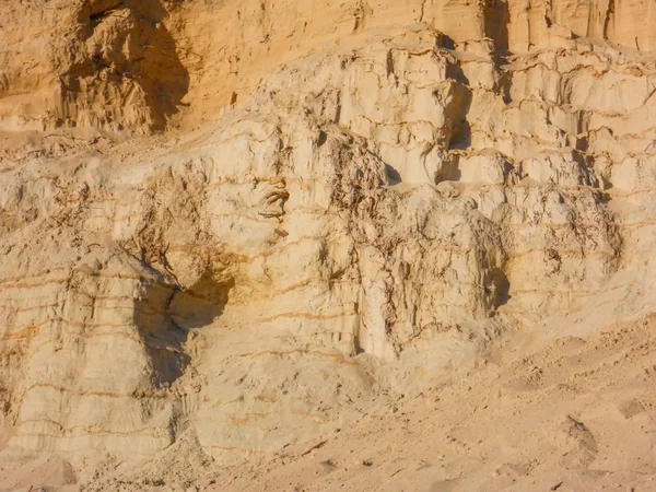 sand wall background made by layers of sand with different densities in a sand pit