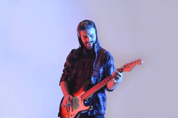 Young man playing the guitar on isolated white background