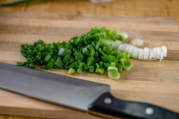 cutting board with knife and onion