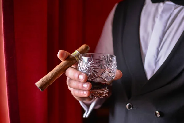 man with cigar and whiskey glass