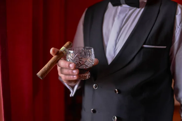 man with cigar and whiskey glass