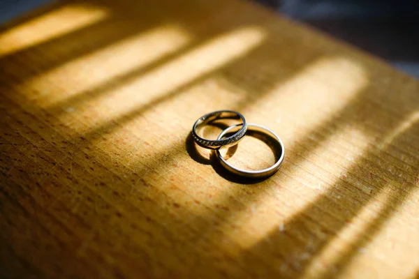 wedding rings on wood background