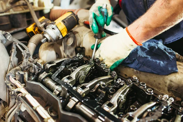 car mechanic repairing truck engine