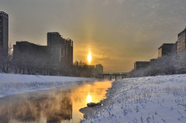 Altın gün batımı ve nehir üzerinde sis - kentsel kış manzara