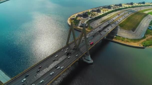 A spectacular bridge across the river and a great city view. We can see a large surface of blue brilliant water. The quadcopter shooting. — Stock Footage Spectacular Bridge River Great City View Can See Large Surface Royalty Free Stock Footage