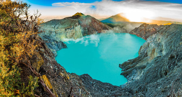 Panoramatic view on Kawah Ijen volcano with trees during beautiful sunrise in East Java in Indonesia