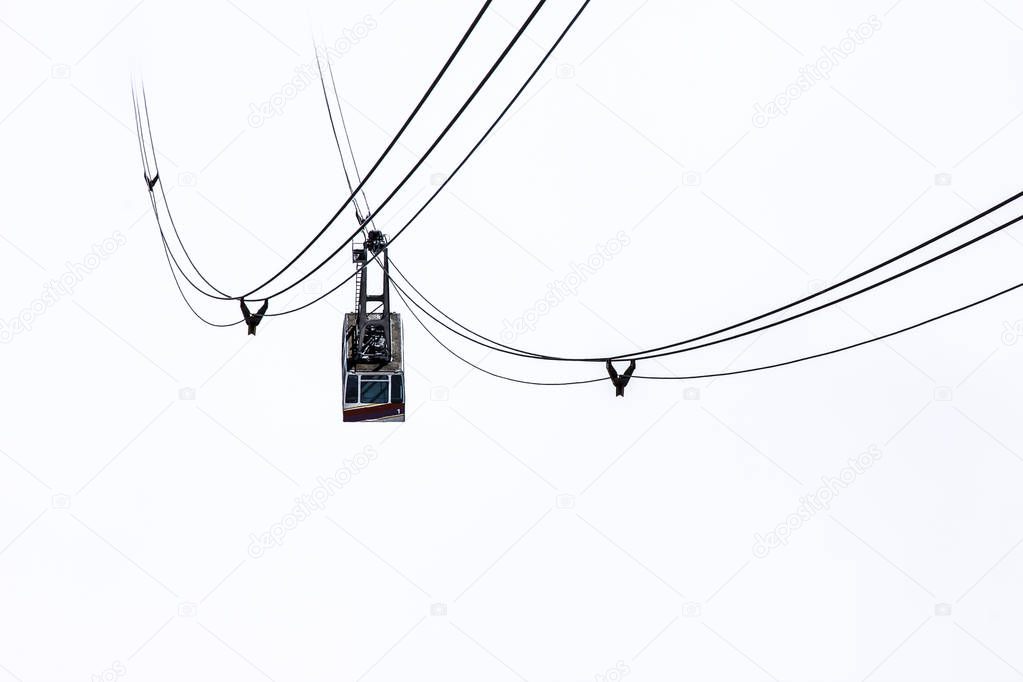 Cable car isolated on white background in foggy mountains, Italy, Dolomites