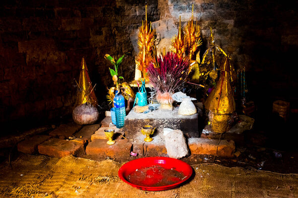 Sacrifice with flowers and incense in mysterious ancient old Phnom Krom Temple in Cambodia