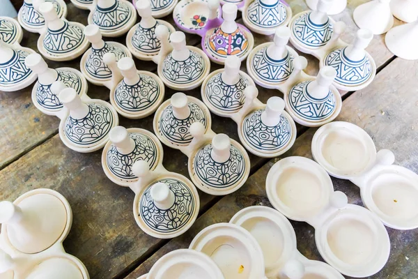 A moroccan pottery maker creates ceramics in a workshop in old medina of Fez, Morocco, Africa