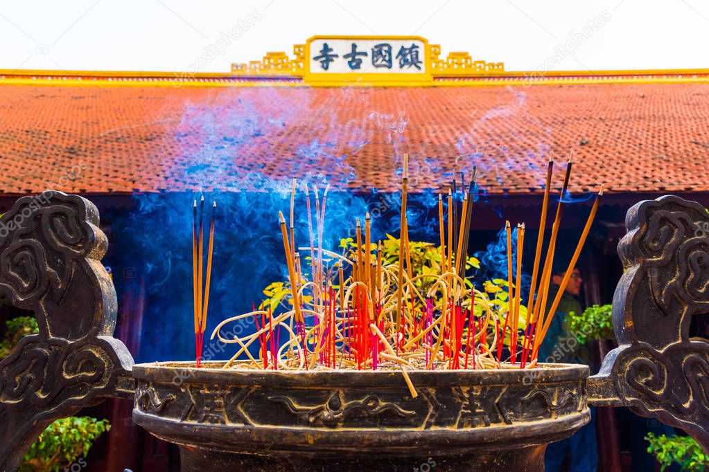Incense sticks in the Buddhist Temple Tran Quoc Pagoda, Symbol of Hanoi in Vietnam