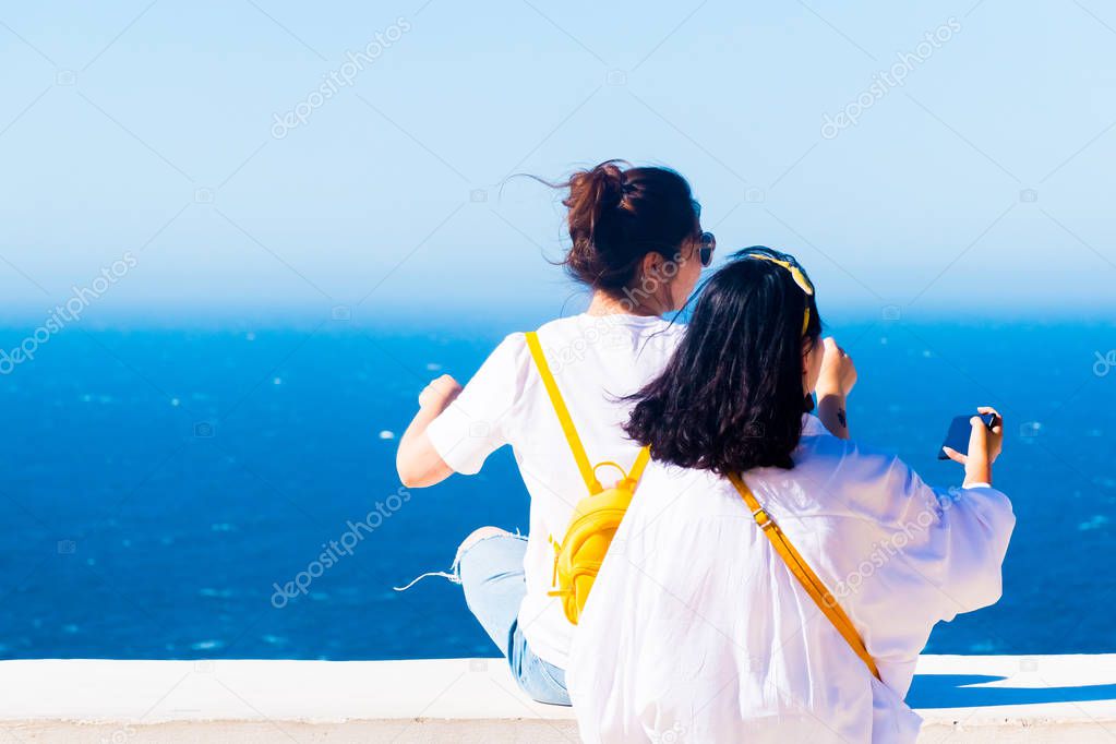 Girls and Lighthouse of Cap Spartel close to Tanger city and Gibraltar, Morocco