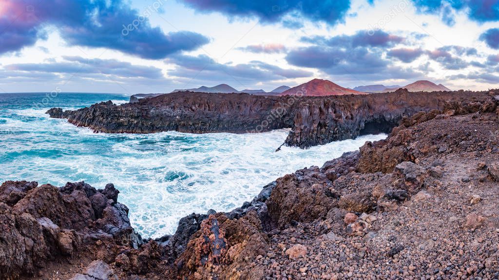 Panorama of the Amazing Los Hervideros lava caves in Lanzarote island at sunset, popular touristic attraction, Canary Islands, Spain