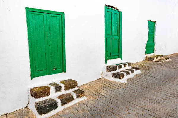 Típica casita canaria con jardín de cactus y puertas verdes o ventanas en la isla de Lanzarote, Teguise, Islas Canarias, España —  Fotos de Stock