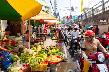 Vietnam, Phu Quoc Adası, 26 Şubat 2018: kimliği belirsiz kadın tipik Vietnamca konik şapkalar ile reçel taze yiyecek kaotik trafik ile bir semt pazarı üzerinde satmak