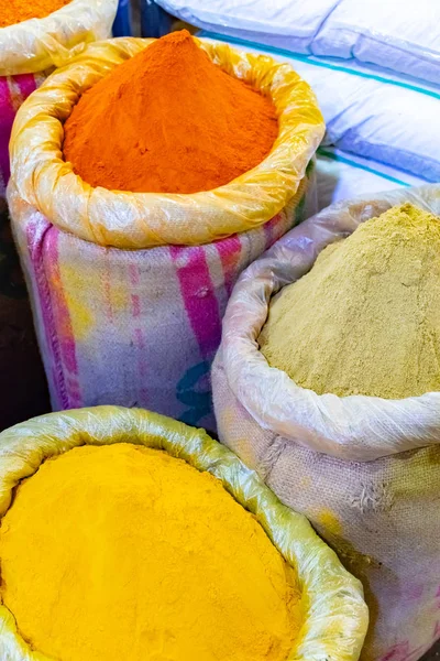 Colorful spices powders of curry and chilli traditional spicy street market in New Delhi. India